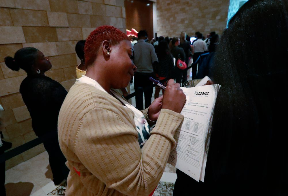 In this June 4, 2019 photo, job applicant Esta Williams, center, uses Tracy Simeton's back to fill out a questionnaire as they wait in line at the Seminole Hard Rock Hotel & Casino Hollywood during a job fair in Hollywood, Fla. On Friday, Aug. 2, the U.S. government issues the July jobs report. (AP Photo/Wilfredo Lee, File) In this June 4, 2019 photo, job applicant Esta Williams, center, uses Tracy Simeton's back to fill out a questionnaire as they wait in line at the Seminole Hard Rock Hotel & Casino Hollywood during a job fair in Hollywood, Fla. On Friday, Aug. 2, the U.S. government issues the July jobs report. (AP Photo/Wilfredo Lee, File)