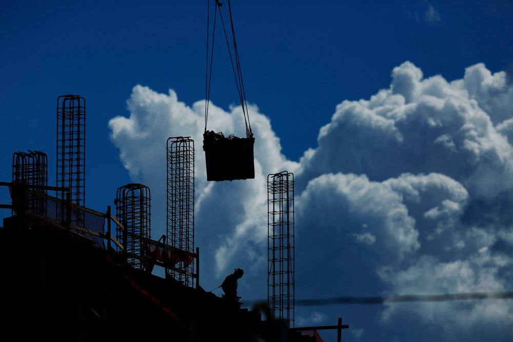 FILE - In this July 2, 2019, file photo a construction worker walks atop a building as a crane lifts a load over head in Miami. On Friday, Aug. 2, the U.S. government issues the July jobs report. (AP Photo/Brynn Anderson, File) FILE - In this July 2, 2019, file photo a construction worker walks atop a building as a crane lifts a load over head in Miami. On Friday, Aug. 2, the U.S. government issues the July jobs report. (AP Photo/Brynn Anderson, File)