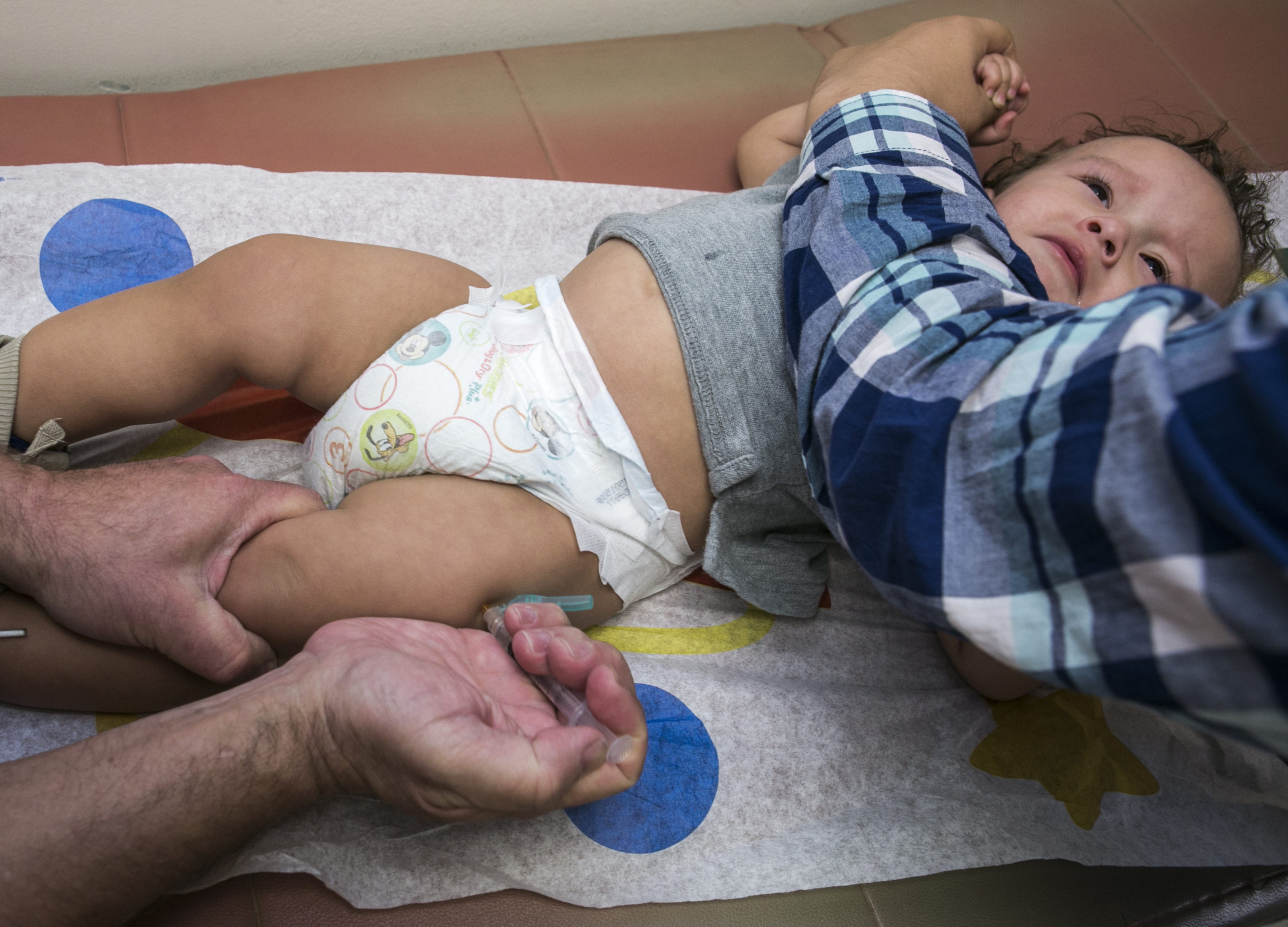 FILE - In this Jan. 29, 2015, file photo, pediatrician Charles Goodman vaccinates 1-year-old Cameron Fierro with the measles-mumps-rubella vaccine, or MMR vaccine, at his practice in Northridge, Calif. A new study published in the journal Science suggests the measles vaccine not only prevents measles, but may also help the body ward off other infections. State health officials say the number of measles cases is up in California this year and much of the increase is linked to overseas travel. Dr. Karen Smith, director of the California Department of Public Health, says the state recorded 38 measles cases as of Thursday, April 25, 2019, versus 11 around the same time last year. She says the state typically sees fewer than two dozen cases a year. (AP Photo/Damian Dovarganes,File) FILE - In this Jan. 29, 2015, file photo, pediatrician Charles Goodman vaccinates 1-year-old Cameron Fierro with the measles-mumps-rubella vaccine, or MMR vaccine, at his practice in Northridge, Calif. A new study published in the journal Science suggests the measles vaccine not only prevents measles, but may also help the body ward off other infections. State health officials say the number of measles cases is up in California this year and much of the increase is linked to overseas travel. Dr. Karen Smith, director of the California Department of Public Health, says the state recorded 38 measles cases as of Thursday, April 25, 2019, versus 11 around the same time last year. She says the state typically sees fewer than two dozen cases a year. (AP Photo/Damian Dovarganes,File)