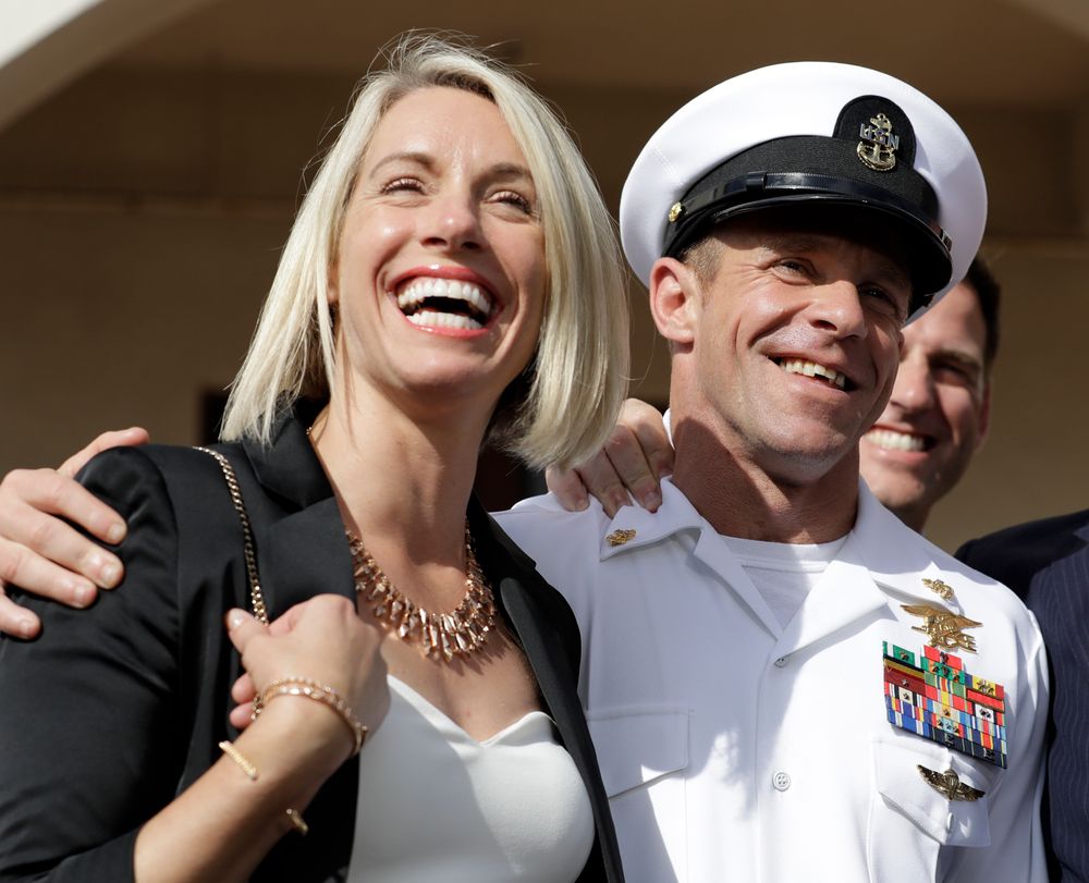 Navy Special Operations Chief Edward Gallagher, left, and his wife, Andrea Gallagher smile after leaving a military court on Naval Base San Diego, Tuesday, July 2, 2019, in San Diego. A military jury acquitted a decorated Navy SEAL of premeditated murder Tuesday in the killing of a wounded Islamic State captive under his care in Iraq in 2017. (AP Photo/Gregory Bull) Navy Special Operations Chief Edward Gallagher, left, and his wife, Andrea Gallagher smile after leaving a military court on Naval Base San Diego, Tuesday, July 2, 2019, in San Diego. A military jury acquitted a decorated Navy SEAL of premeditated murder Tuesday in the killing of a wounded Islamic State captive under his care in Iraq in 2017. (AP Photo/Gregory Bull)