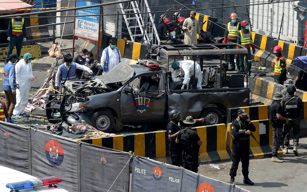 Pakistani security personnel surround a damaged police van in Lahore, Pakistan, Wednesday, May 8, 2019. A powerful bomb exploded near security forces guarding a famous Sufi shrine in Pakistan on Wednesday, police said. (AP Photo/K.M. Chaudary) Pakistani security personnel surround a damaged police van in Lahore, Pakistan, Wednesday, May 8, 2019. A powerful bomb exploded near security forces guarding a famous Sufi shrine in Pakistan on Wednesday, police said. (AP Photo/K.M. Chaudary)