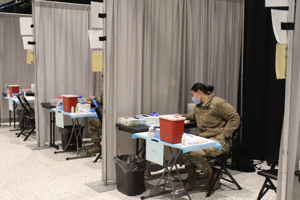 A Rhode Island National Guard member prepares to administer the Pfizer vaccine at the Rhode Island Convention Center.