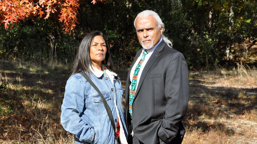 Randy Noka, right, and his wife, Bella Noka, pose for a photo at the 32-acre property in Charlestown where the Narragansett Indian Tribe tried for years to build affordable housing.