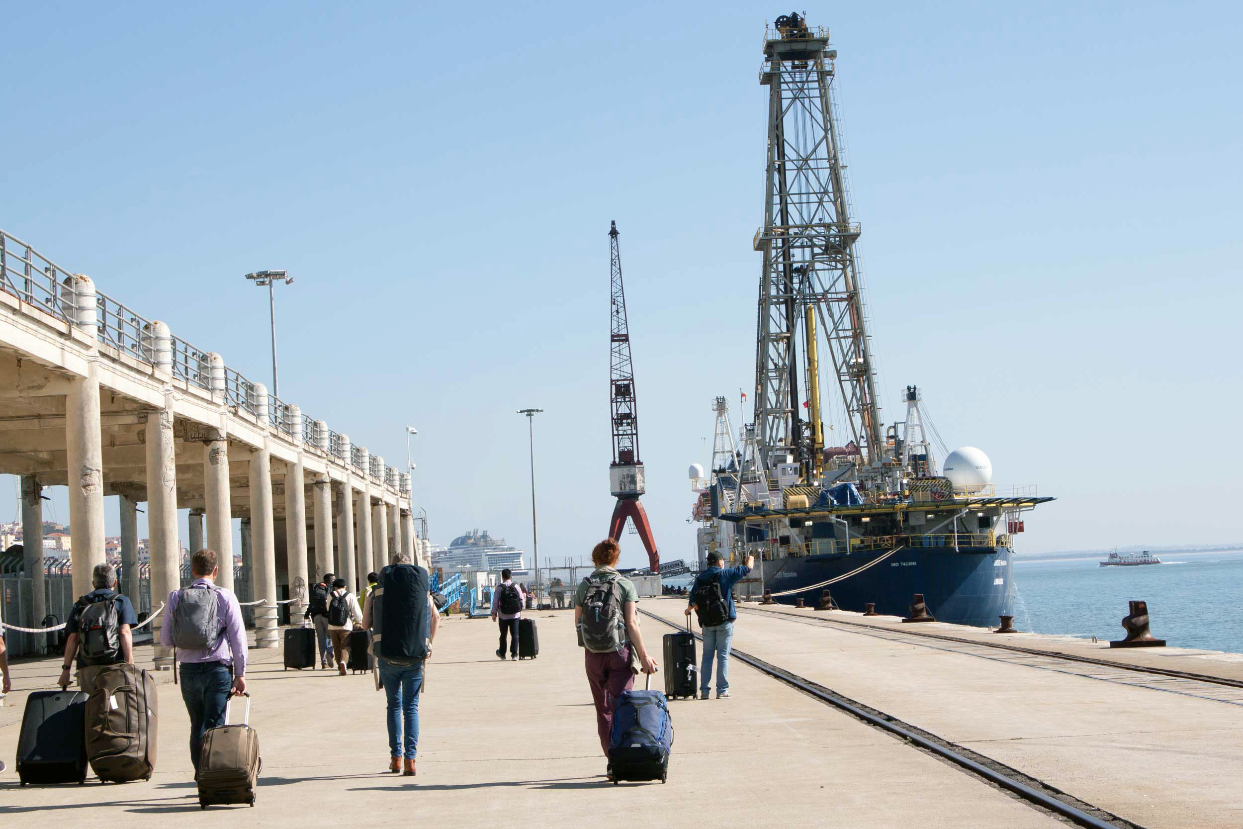 David Hodell, far left, Tim Herbert, second from left, and other members of International Ocean Discovery Program’s Expedition 397 walk out to the JOIDES Resolution at a dock in the Port of Lisbon on Oct. 13, 2022. 