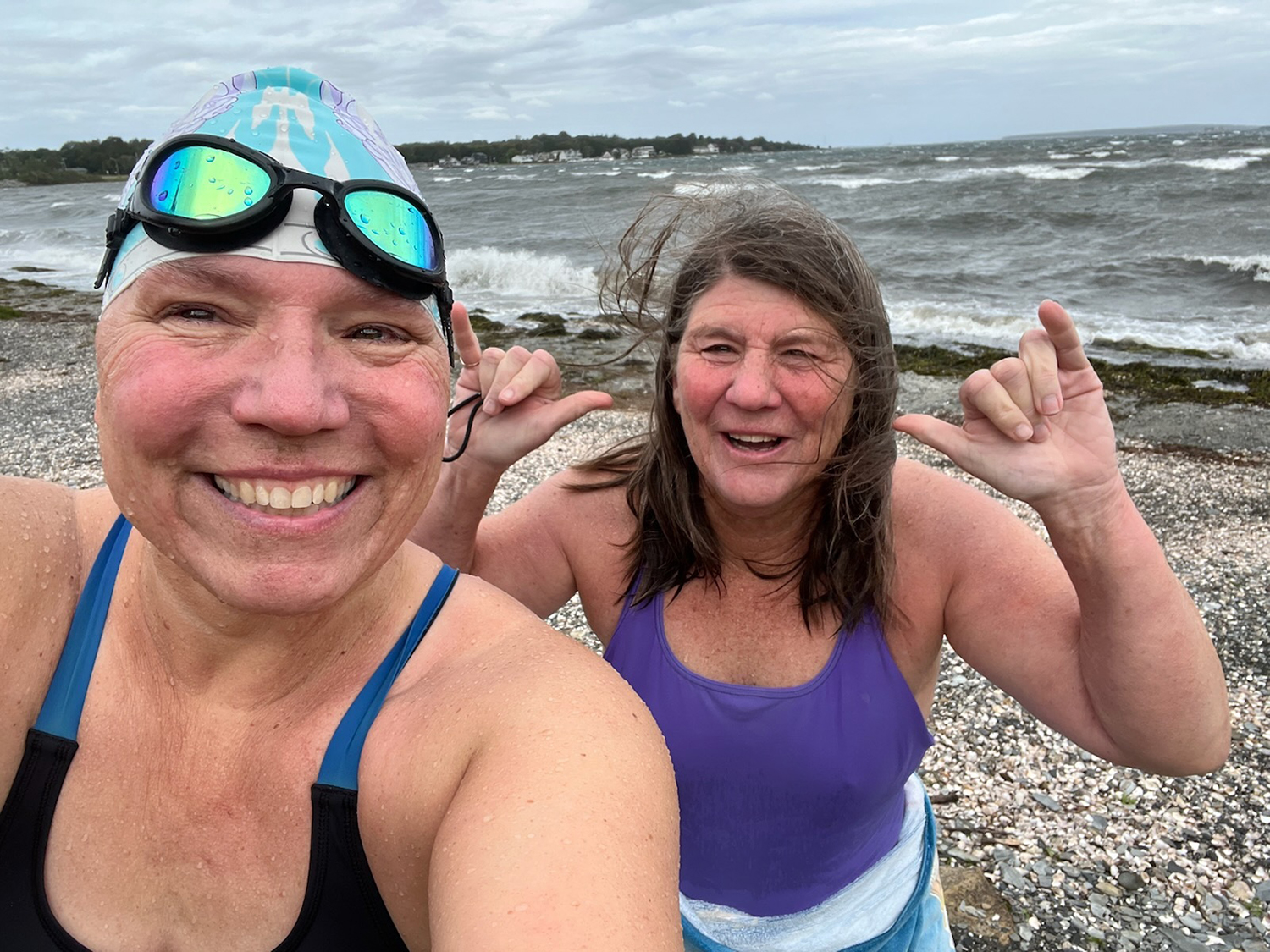 During a ripping northeast wind, Cathy Davis Hayes takes a selfie with Cheryl Hatch after a swim on a blustery day at Potter Cover in Jamestown, Rhode Island, on Oct. 2, 2022.