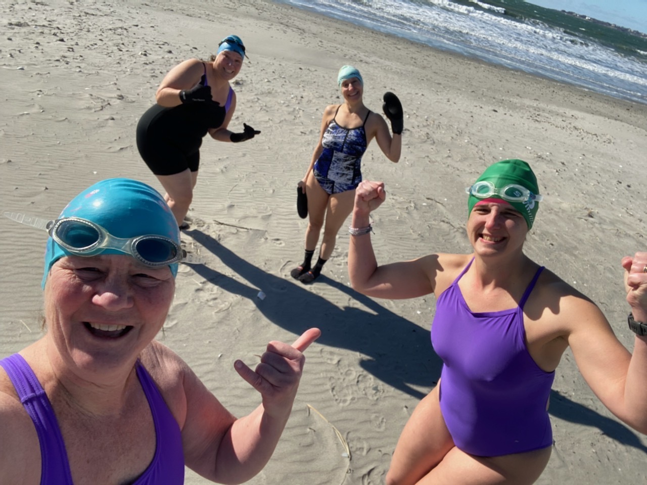 Before a swim at Sachuest Beach, Cheryl Hatch takes a selfie with Cathy Davis Hayes, from left, Natalie Coletta and Christina Lorenson, in Middletown, Rhode Island, on Feb. 19, 2022.
