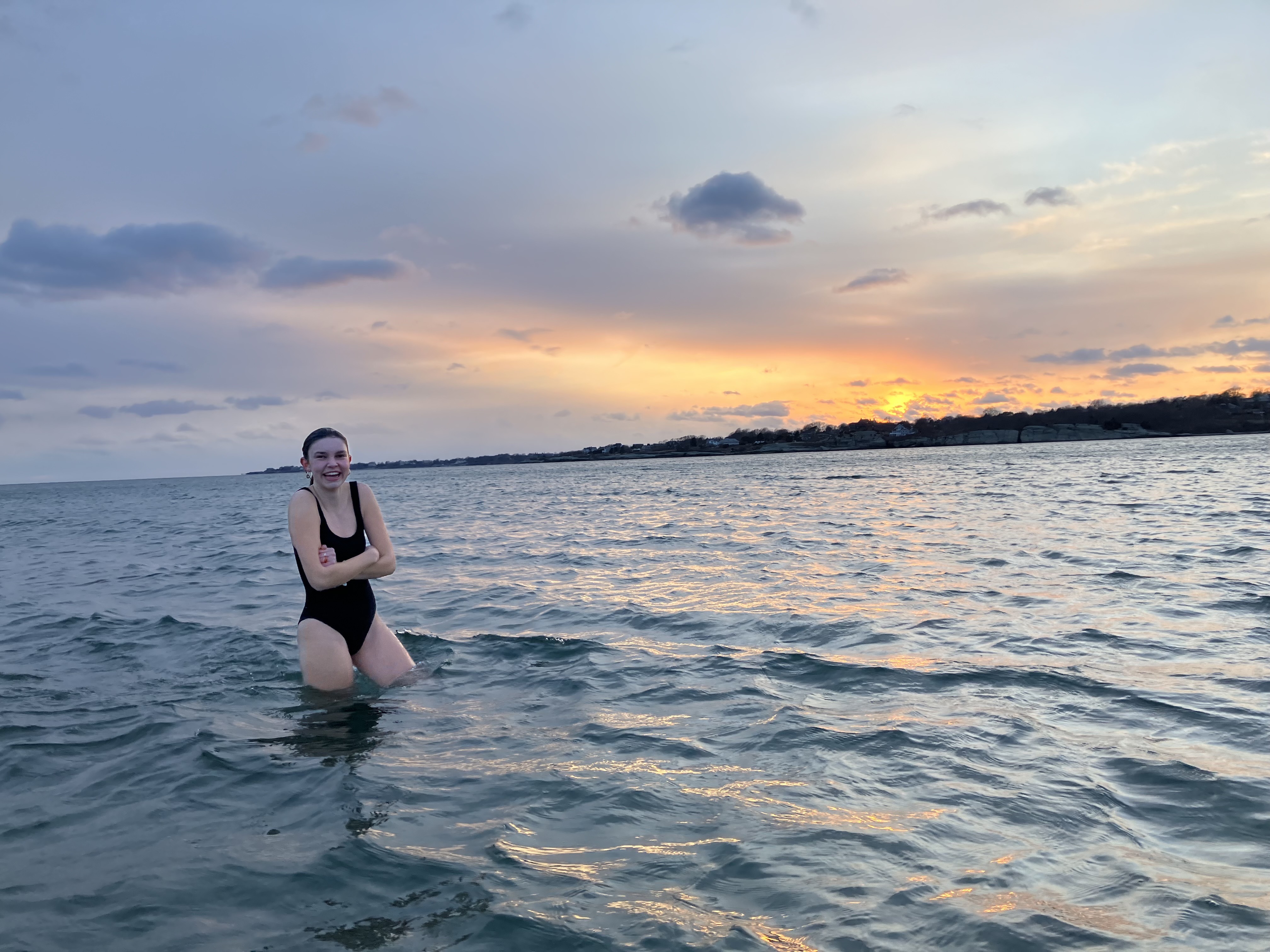 Molly Woodhouse smiles as she exits the water after a sunset swim at Sachuest Beach in Middletown, Rhode Island, on Tuesday, March 7, 2023. Molly is a senior in nursing at Salve Regina University in Newport, Rhode Island.