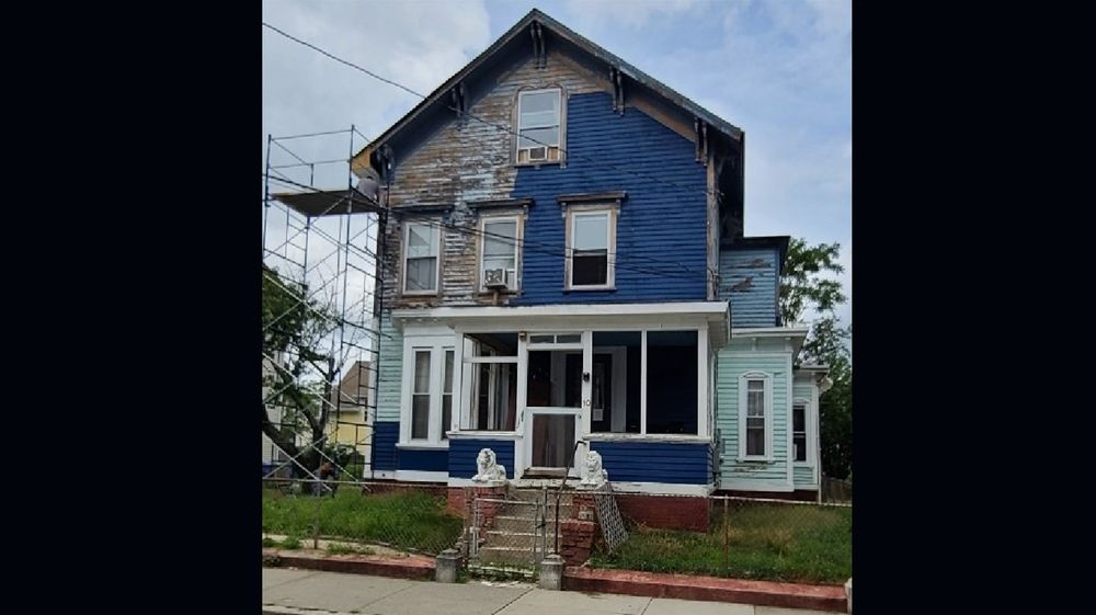  Omar Benitez repainted the exterior of his Central Falls house to contain peeling lead-based paint. 