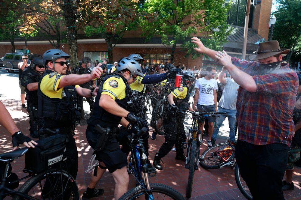After a confrontation between authorities and protestors, police use pepper spray as multiple groups, including Rose City Antifa, the Proud Boys and others protest in downtown Portland, Ore., on Saturday, June 29, 2019. In separate social media posts later in the day, police declared the situation to be a civil disturbance and warned participants faced arrest. (Dave Killen/The Oregonian via AP) After a confrontation between authorities and protestors, police use pepper spray as multiple groups, including Rose City Antifa, the Proud Boys and others protest in downtown Portland, Ore., on Saturday, June 29, 2019. In separate social media posts later in the day, police declared the situation to be a civil disturbance and warned participants faced arrest. (Dave Killen/The Oregonian via AP)