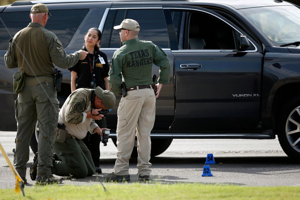 Law enforcement officials process a scene involved in Saturday's shooting, Sunday, Sept. 1, 2019, in Odessa, Texas. The death toll in the West Texas shooting rampage increased Sunday as authorities investigated why a man stopped by state troopers for failing to signal a left turn opened fire on them and fled, shooting more than a dozen people as he drove before being killed by officers outside a movie theater. (AP Photo/Sue Ogrocki) Law enforcement officials process a scene involved in Saturday's shooting, Sunday, Sept. 1, 2019, in Odessa, Texas. The death toll in the West Texas shooting rampage increased Sunday as authorities investigated why a man stopped by state troopers for failing to signal a left turn opened fire on them and fled, shooting more than a dozen people as he drove before being killed by officers outside a movie theater. (AP Photo/Sue Ogrocki)