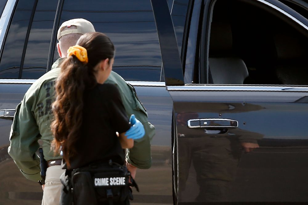 Bullet holes appear near a door handle of a car as law enforcement officials process a scene involved in Saturday's shooting, Sunday, Sept. 1, 2019, in Odessa, Texas. The death toll in the West Texas shooting rampage increased Sunday as authorities investigated why a man stopped by state troopers for failing to signal a left turn opened fire on them and fled, shooting more than a dozen people as he drove before being killed by officers outside a movie theater. (AP Photo/Sue Ogrocki) Bullet holes appear near a door handle of a car as law enforcement officials process a scene involved in Saturday's shooting, Sunday, Sept. 1, 2019, in Odessa, Texas. The death toll in the West Texas shooting rampage increased Sunday as authorities investigated why a man stopped by state troopers for failing to signal a left turn opened fire on them and fled, shooting more than a dozen people as he drove before being killed by officers outside a movie theater. (AP Photo/Sue Ogrocki)