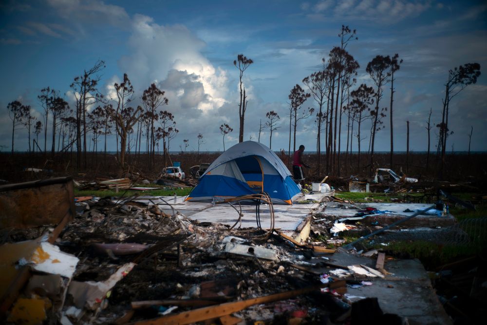 A man searches in the rubble of his house destroyed by Hurricane Dorian in Rocky Creek East, Grand Bahama, Bahamas, Thursday Sept. 12, 2019. Nearly two weeks after Hurricane Dorian hit the northern Bahamas, people continue to scan social media, peer under rubble or follow the smell of death in an attempt to find family and friends. (AP Photo/Ramon Espinosa) A man searches in the rubble of his house destroyed by Hurricane Dorian in Rocky Creek East, Grand Bahama, Bahamas, Thursday Sept. 12, 2019. Nearly two weeks after Hurricane Dorian hit the northern Bahamas, people continue to scan social media, peer under rubble or follow the smell of death in an attempt to find family and friends. (AP Photo/Ramon Espinosa)