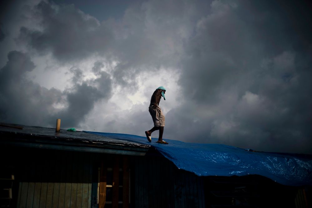 Trevon Laing walks the roof of his house to repair the damage made by Hurricane Dorian, in Gold Rock Creek, Grand Bahama, Bahamas, Thursday Sept. 12, 2019. Trevor says Trevon Laing walks the roof of his house to repair the damage made by Hurricane Dorian, in Gold Rock Creek, Grand Bahama, Bahamas, Thursday Sept. 12, 2019. Trevor says