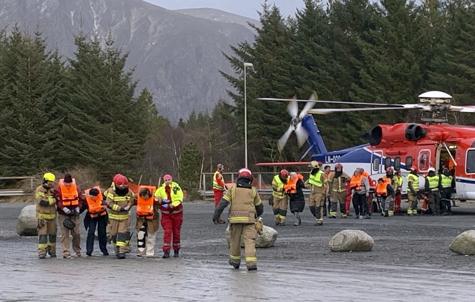 Passengers rescued from the Viking Sky cruise ship are helped from a helicopter in Hustadvika, Norway, Saturday March 23, 2019. A cruise ship with engine problems sent a mayday call off Norway's western coast on Saturday, then began evacuating its 1,300 passengers and crew amid stormy seas and heavy winds in a high-risk helicopter rescue operation. (Odd Roar Lange/NTB Scanpix via AP) Passengers rescued from the Viking Sky cruise ship are helped from a helicopter in Hustadvika, Norway, Saturday March 23, 2019. A cruise ship with engine problems sent a mayday call off Norway's western coast on Saturday, then began evacuating its 1,300 passengers and crew amid stormy seas and heavy winds in a high-risk helicopter rescue operation. (Odd Roar Lange/NTB Scanpix via AP)