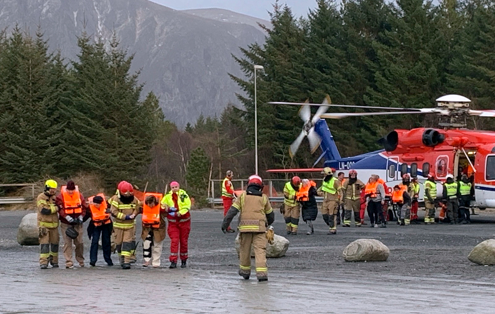Passengers rescued from the Viking Sky cruise ship are helped from a helicopter in Hustadvika, Norway, Saturday March 23, 2019. A cruise ship with engine problems sent a mayday call off Norway's western coast on Saturday, then began evacuating its 1,300 passengers and crew amid stormy seas and heavy winds in a high-risk helicopter rescue operation. (Odd Roar Lange/NTB Scanpix via AP) Passengers rescued from the Viking Sky cruise ship are helped from a helicopter in Hustadvika, Norway, Saturday March 23, 2019. A cruise ship with engine problems sent a mayday call off Norway's western coast on Saturday, then began evacuating its 1,300 passengers and crew amid stormy seas and heavy winds in a high-risk helicopter rescue operation. (Odd Roar Lange/NTB Scanpix via AP)