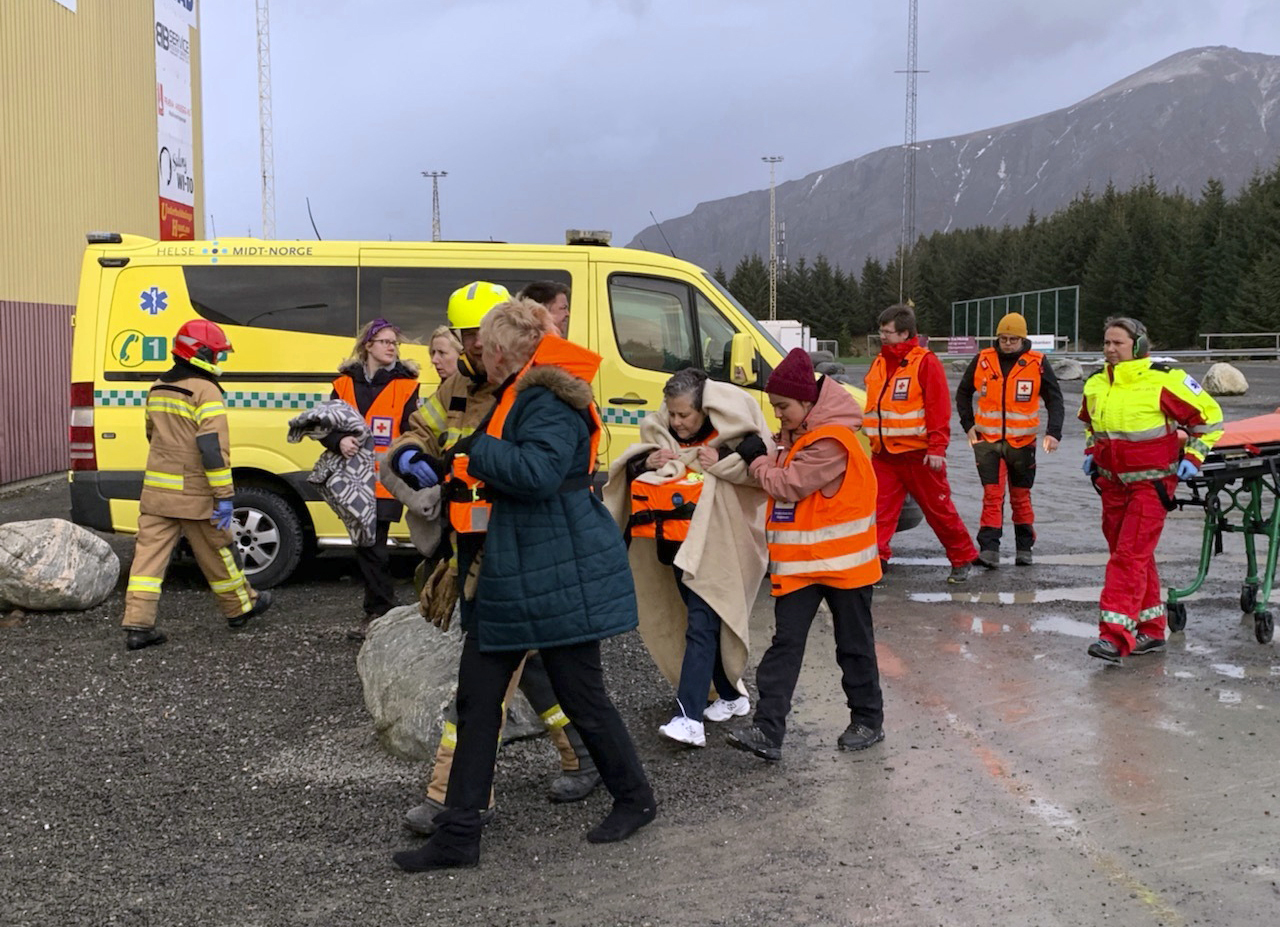 Passengers rescued from the Viking Sky cruise ship are helped from a helicopter in Hustadvika, Norway, Saturday March 23, 2019. A cruise ship with engine problems sent a mayday call off Norway's western coast on Saturday, then began evacuating its 1,300 passengers and crew amid stormy seas and heavy winds in a high-risk helicopter rescue operation. (Odd Roar Lange/NTB Scanpix via AP) Passengers rescued from the Viking Sky cruise ship are helped from a helicopter in Hustadvika, Norway, Saturday March 23, 2019. A cruise ship with engine problems sent a mayday call off Norway's western coast on Saturday, then began evacuating its 1,300 passengers and crew amid stormy seas and heavy winds in a high-risk helicopter rescue operation. (Odd Roar Lange/NTB Scanpix via AP)