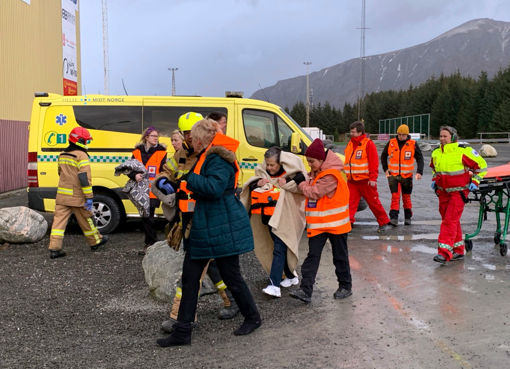 Passengers rescued from the Viking Sky cruise ship are helped from a helicopter in Hustadvika, Norway, Saturday March 23, 2019. A cruise ship with engine problems sent a mayday call off Norway's western coast on Saturday, then began evacuating its 1,300 passengers and crew amid stormy seas and heavy winds in a high-risk helicopter rescue operation. (Odd Roar Lange/NTB Scanpix via AP) Passengers rescued from the Viking Sky cruise ship are helped from a helicopter in Hustadvika, Norway, Saturday March 23, 2019. A cruise ship with engine problems sent a mayday call off Norway's western coast on Saturday, then began evacuating its 1,300 passengers and crew amid stormy seas and heavy winds in a high-risk helicopter rescue operation. (Odd Roar Lange/NTB Scanpix via AP)