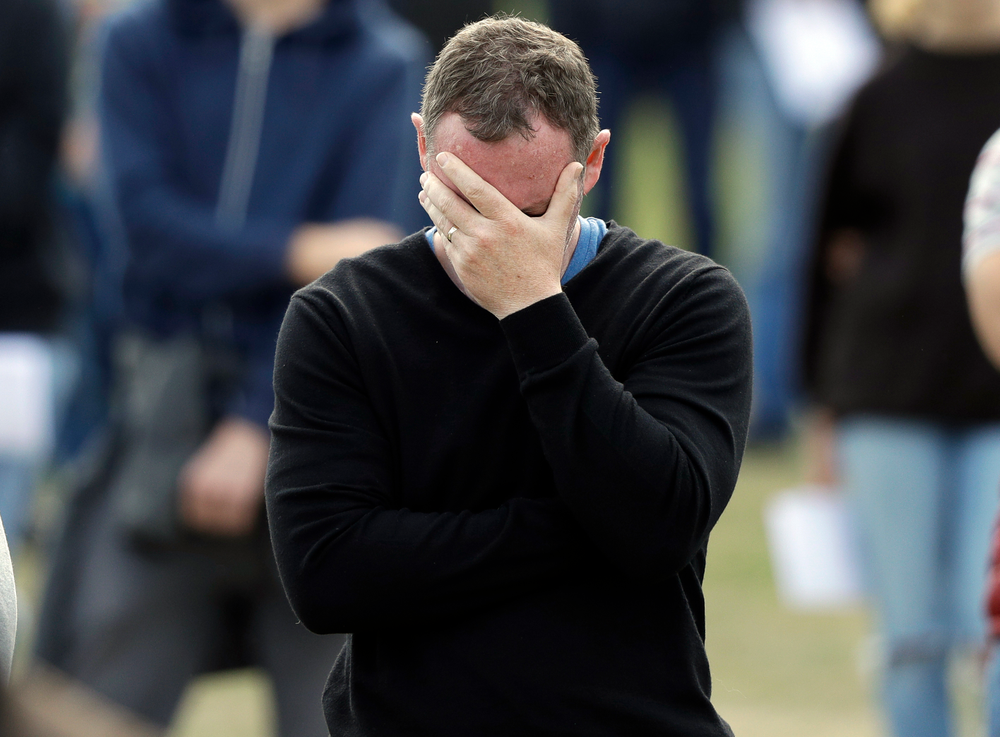 A man reacts during a national remembrance service in Hagley Park for the victims of the March 15 mosque terrorist attack in Christchurch, New Zealand, Friday, March 29, 2019. (AP Photo/Mark Baker) A man reacts during a national remembrance service in Hagley Park for the victims of the March 15 mosque terrorist attack in Christchurch, New Zealand, Friday, March 29, 2019. (AP Photo/Mark Baker)