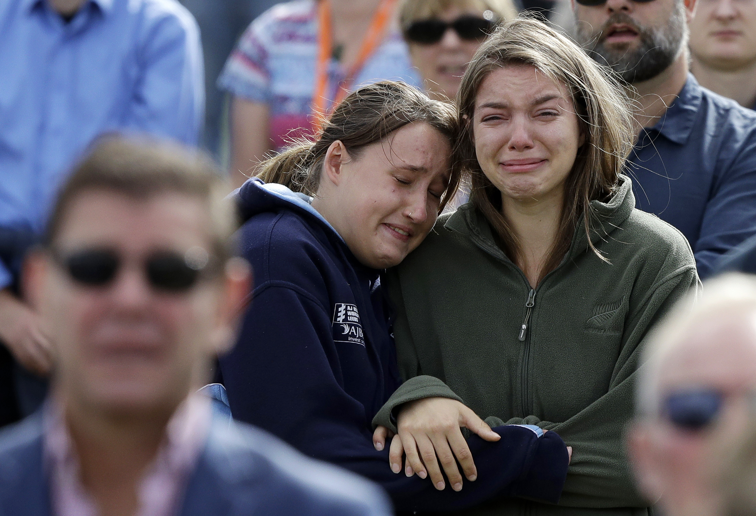 In this Friday, March 29, 2019, file photo, women react as the New Zealand national anthem is sung during a national remembrance service in Hagley Park for the victims of the March 15 mosque terrorist attack in Christchurch, New Zealand. (AP Photo/Mark Baker, File) In this Friday, March 29, 2019, file photo, women react as the New Zealand national anthem is sung during a national remembrance service in Hagley Park for the victims of the March 15 mosque terrorist attack in Christchurch, New Zealand. (AP Photo/Mark Baker, File)