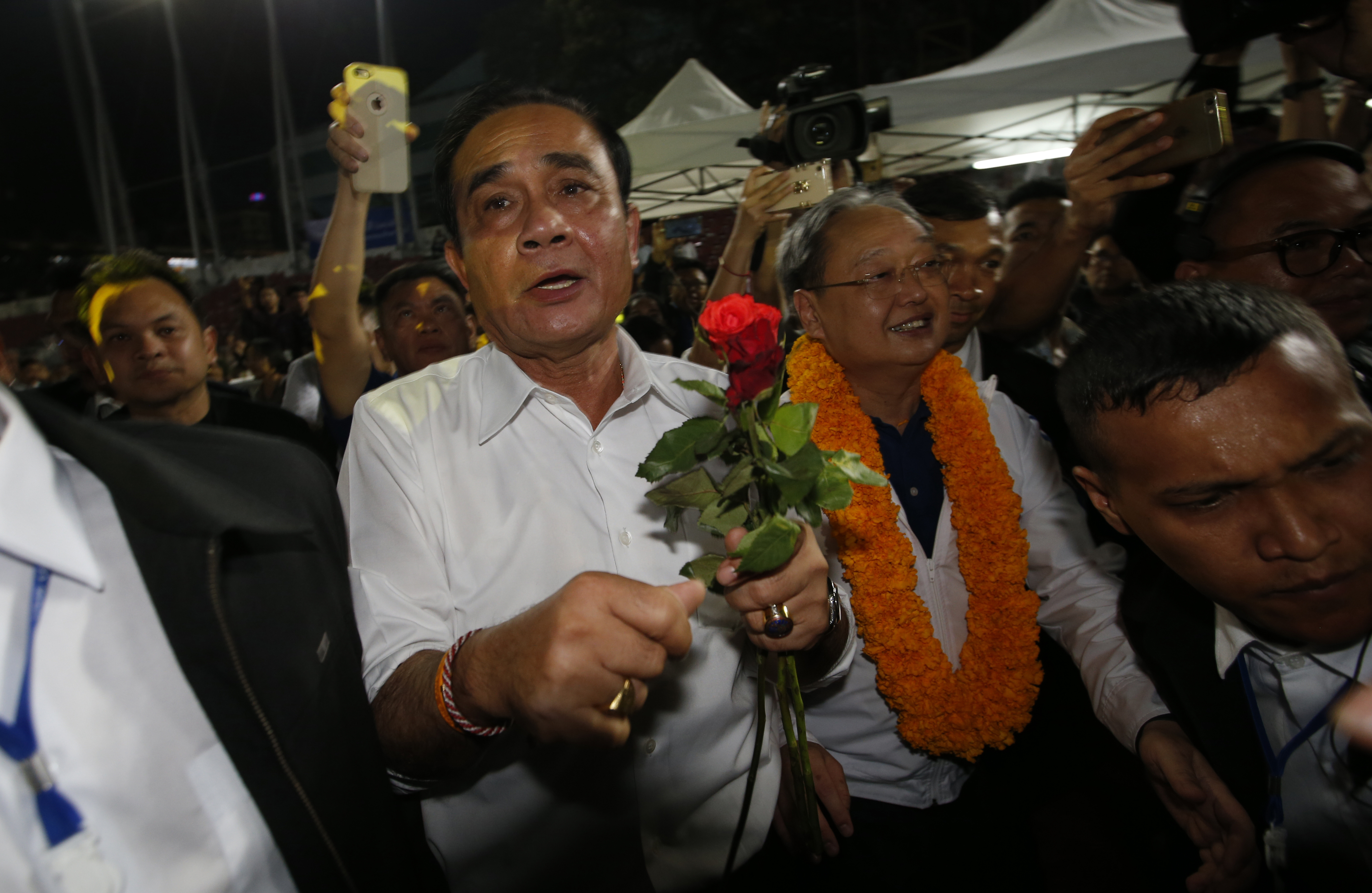 Thai Prime Minister Prayuth Chan-ocha of the Palang Pracharat Party receives flowers from supporters during an election campaign rally in Bangkok, Thailand, Friday, March 22, 2019. The political movement that has won every Thai election in nearly two decades is facing its biggest test yet: Squaring off against the allies of the military junta that removed it from power and rewrote the electoral rules with the goal of putting an end to those victories. (AP Photo/Sakchai Lalit) Thai Prime Minister Prayuth Chan-ocha of the Palang Pracharat Party receives flowers from supporters during an election campaign rally in Bangkok, Thailand, Friday, March 22, 2019. The political movement that has won every Thai election in nearly two decades is facing its biggest test yet: Squaring off against the allies of the military junta that removed it from power and rewrote the electoral rules with the goal of putting an end to those victories. (AP Photo/Sakchai Lalit)