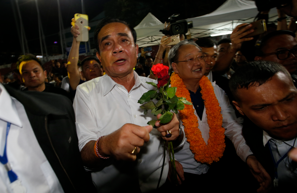 Thai Prime Minister Prayuth Chan-ocha of the Palang Pracharat Party receives flowers from supporters during an election campaign rally in Bangkok, Thailand, Friday, March 22, 2019. The political movement that has won every Thai election in nearly two decades is facing its biggest test yet: Squaring off against the allies of the military junta that removed it from power and rewrote the electoral rules with the goal of putting an end to those victories. (AP Photo/Sakchai Lalit) Thai Prime Minister Prayuth Chan-ocha of the Palang Pracharat Party receives flowers from supporters during an election campaign rally in Bangkok, Thailand, Friday, March 22, 2019. The political movement that has won every Thai election in nearly two decades is facing its biggest test yet: Squaring off against the allies of the military junta that removed it from power and rewrote the electoral rules with the goal of putting an end to those victories. (AP Photo/Sakchai Lalit)