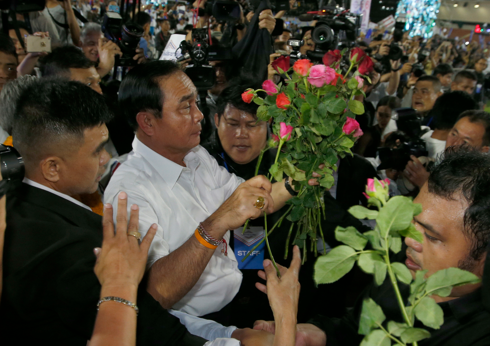 Thai Prime Minister Prayuth Chan-ocha of the Palang Pracharat Party receives flowers from supporters during an election campaign rally in Bangkok, Thailand, Friday, March 22, 2019. The political movement that has won every Thai election in nearly two decades is facing its biggest test yet: Squaring off against the allies of the military junta that removed it from power and rewrote the electoral rules with the goal of putting an end to those victories. (AP Photo/Sakchai Lalit) Thai Prime Minister Prayuth Chan-ocha of the Palang Pracharat Party receives flowers from supporters during an election campaign rally in Bangkok, Thailand, Friday, March 22, 2019. The political movement that has won every Thai election in nearly two decades is facing its biggest test yet: Squaring off against the allies of the military junta that removed it from power and rewrote the electoral rules with the goal of putting an end to those victories. (AP Photo/Sakchai Lalit)