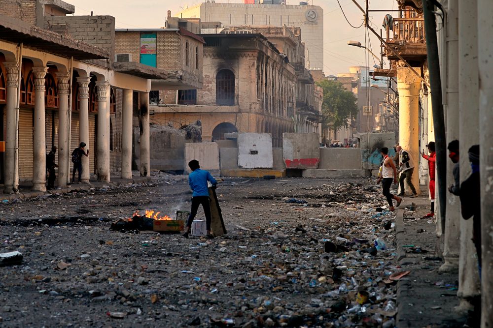Demonstrators gather during clashes between security forces and anti-government protesters in the historic Rasheed Street, Baghdad, Iraq, Sunday, Nov. 24, 2019. Hundreds of people have died since demonstrations began Oct. 1, when thousands of Iraqis, mostly youth, took to the streets to decry corruption and poor services. The leaderless uprising seeks to overthrow the political establishment. (AP Photo/Khalid Mohammed) Demonstrators gather during clashes between security forces and anti-government protesters in the historic Rasheed Street, Baghdad, Iraq, Sunday, Nov. 24, 2019. Hundreds of people have died since demonstrations began Oct. 1, when thousands of Iraqis, mostly youth, took to the streets to decry corruption and poor services. The leaderless uprising seeks to overthrow the political establishment. (AP Photo/Khalid Mohammed)