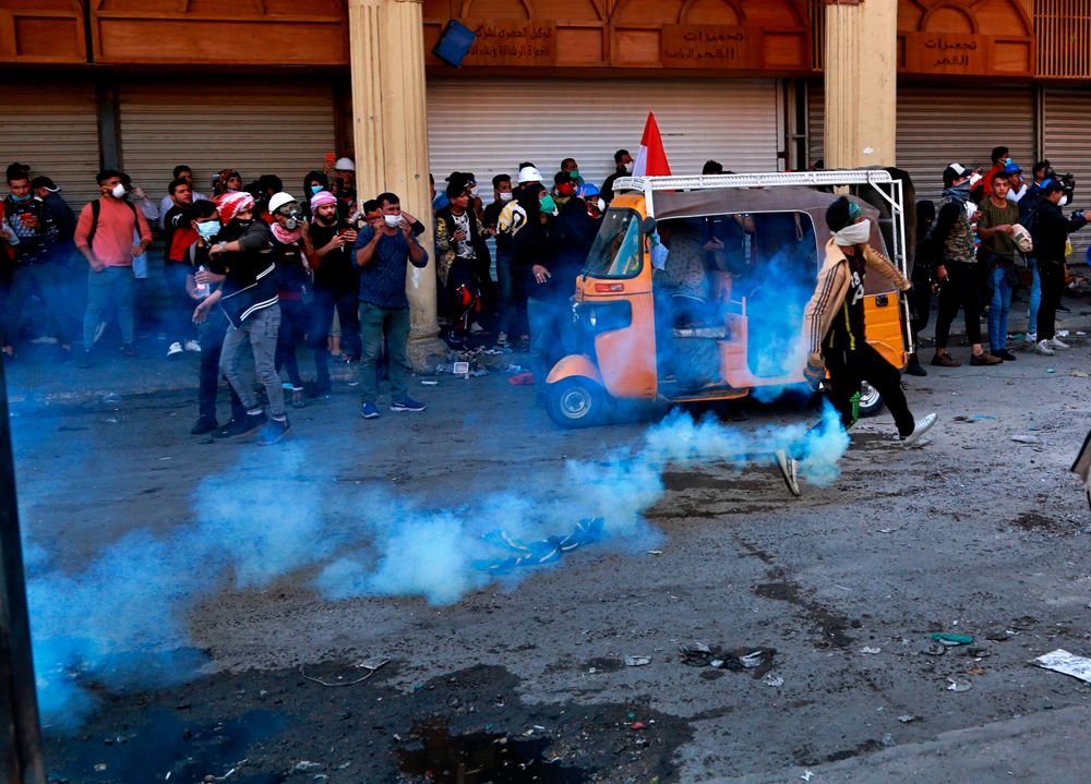 Riot police fire tear gas during clashes with anti-government protesters in Baghdad, Iraq, Sunday, Nov. 24, 2019. (AP Photo/Khalid Mohammed) Riot police fire tear gas during clashes with anti-government protesters in Baghdad, Iraq, Sunday, Nov. 24, 2019. (AP Photo/Khalid Mohammed)