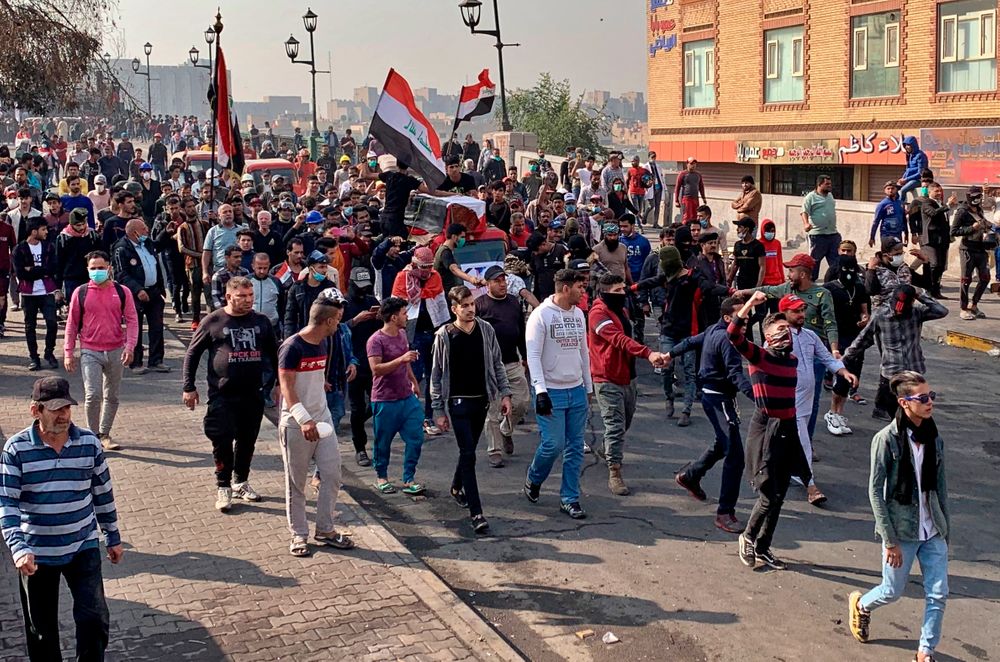 Mourners and protesters escort the flag-draped coffin of Munir Ali, whose family said was killed in anti-government demonstrations, during his funeral in Baghdad, Iraq, Sunday, Nov. 24, 2019. (AP Photo/Ali Abdul Hassan) Mourners and protesters escort the flag-draped coffin of Munir Ali, whose family said was killed in anti-government demonstrations, during his funeral in Baghdad, Iraq, Sunday, Nov. 24, 2019. (AP Photo/Ali Abdul Hassan)