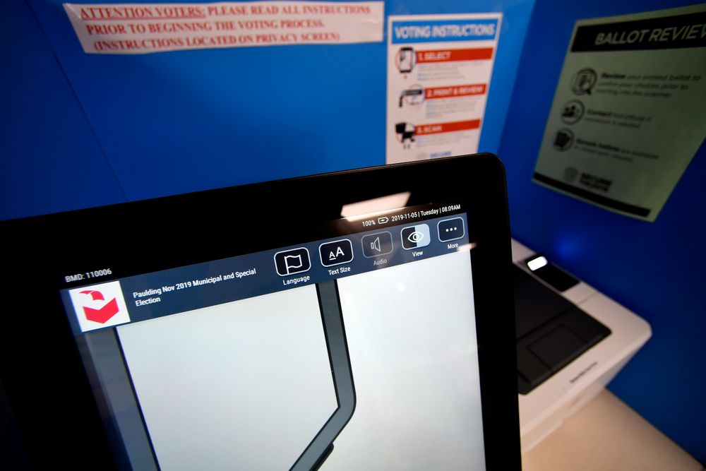 A touchscreen voting machine and printer are seen in a voting booth, Tuesday, Nov. 5, 2019, in Paulding, Ga. New voting machines that combine touchscreens with paper ballots are getting a limited test run in Georgia as officials rush to meet a court-ordered deadline to retire the old system before any votes are cast in 2020. (AP Photo/Mike Stewart) A touchscreen voting machine and printer are seen in a voting booth, Tuesday, Nov. 5, 2019, in Paulding, Ga. New voting machines that combine touchscreens with paper ballots are getting a limited test run in Georgia as officials rush to meet a court-ordered deadline to retire the old system before any votes are cast in 2020. (AP Photo/Mike Stewart)
