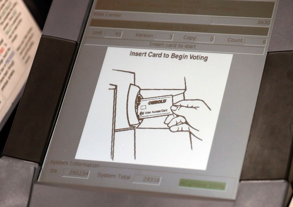 FILE - This May 9, 2018, photo shows a touch screen of a voting machine during early voting in Sandy Springs, Ga. New voting machines that combine touchscreens with paper ballots are getting a limited test run in Georgia. It's part of an effort to meet a court-ordered deadline to retire the old touchscreen only system before any votes are cast in 2020. (AP Photo/John Bazemore, File) FILE - This May 9, 2018, photo shows a touch screen of a voting machine during early voting in Sandy Springs, Ga. New voting machines that combine touchscreens with paper ballots are getting a limited test run in Georgia. It's part of an effort to meet a court-ordered deadline to retire the old touchscreen only system before any votes are cast in 2020. (AP Photo/John Bazemore, File)