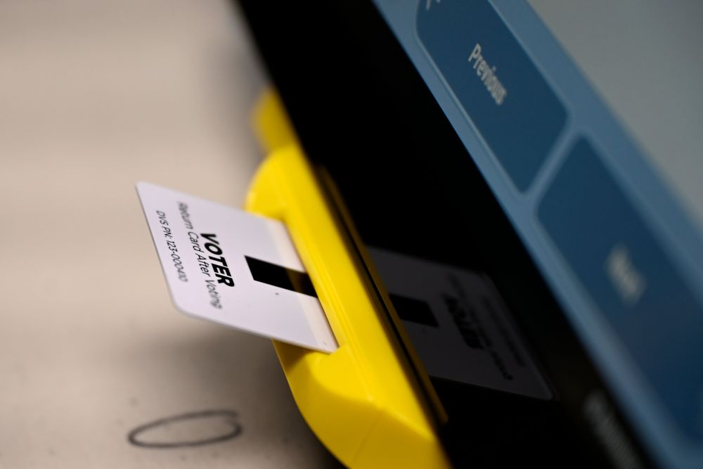 An electronic card with ballot information is seen inserted in a voting machine, Tuesday, Nov. 5, 2019, in Dallas, Ga. New voting machines that combine touchscreens with paper ballots are getting a limited test run in Georgia, as officials rush to meet a court-ordered deadline to retire the old system before any votes are cast in 2020. (AP Photo/Mike Stewart) An electronic card with ballot information is seen inserted in a voting machine, Tuesday, Nov. 5, 2019, in Dallas, Ga. New voting machines that combine touchscreens with paper ballots are getting a limited test run in Georgia, as officials rush to meet a court-ordered deadline to retire the old system before any votes are cast in 2020. (AP Photo/Mike Stewart)