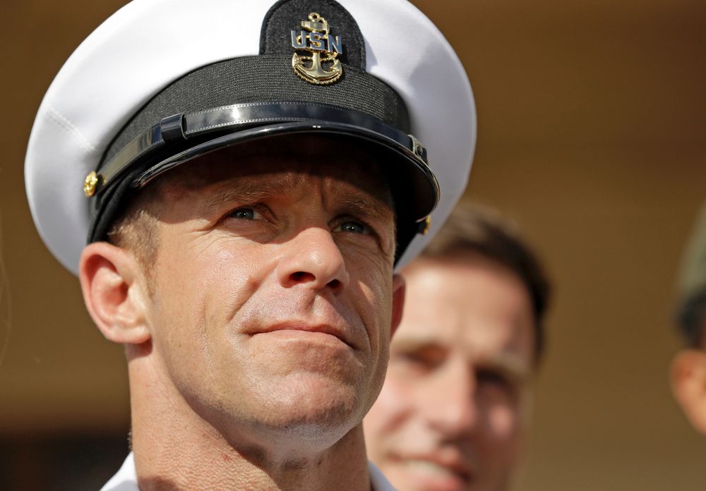 FILE - In this Tuesday, July 2, 2019, file photo, Navy Special Operations Chief Edward Gallagher leaves a military court on Naval Base San Diego. The attorney for Gallagher, convicted of posing with a dead captive in Iraq, says the Navy is trying to remove the special operations chief from the elite fighting force in retaliation for President Donald Trump restoring his rank. Defense attorney Timothy Parlatore said the Navy is holding a review board proceeding to remove Edward Gallagher's Trident pin and summoned him to meet with the SEAL leadership on Wednesday, Nov. 20, 2019. (AP Photo/Gregory Bull, File) FILE - In this Tuesday, July 2, 2019, file photo, Navy Special Operations Chief Edward Gallagher leaves a military court on Naval Base San Diego. The attorney for Gallagher, convicted of posing with a dead captive in Iraq, says the Navy is trying to remove the special operations chief from the elite fighting force in retaliation for President Donald Trump restoring his rank. Defense attorney Timothy Parlatore said the Navy is holding a review board proceeding to remove Edward Gallagher's Trident pin and summoned him to meet with the SEAL leadership on Wednesday, Nov. 20, 2019. (AP Photo/Gregory Bull, File)