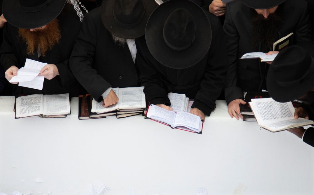 In this Nov. 22, 2019, photo, Hasidic leaders read personal notes and prayers at the resting place of the late Rabbi Menachem Mendel Schneerson, known as the Lubavitcher Rebbe, while attending the annual International Conference of Chabad-Lubavitch Emissaries at Montefiore Cemetery in New York. The annual conference included seminars, a class photo of about 5,800 rabbis in attendance and an evening dinner. (AP Photo/Jessie Wardarski) In this Nov. 22, 2019, photo, Hasidic leaders read personal notes and prayers at the resting place of the late Rabbi Menachem Mendel Schneerson, known as the Lubavitcher Rebbe, while attending the annual International Conference of Chabad-Lubavitch Emissaries at Montefiore Cemetery in New York. The annual conference included seminars, a class photo of about 5,800 rabbis in attendance and an evening dinner. (AP Photo/Jessie Wardarski)