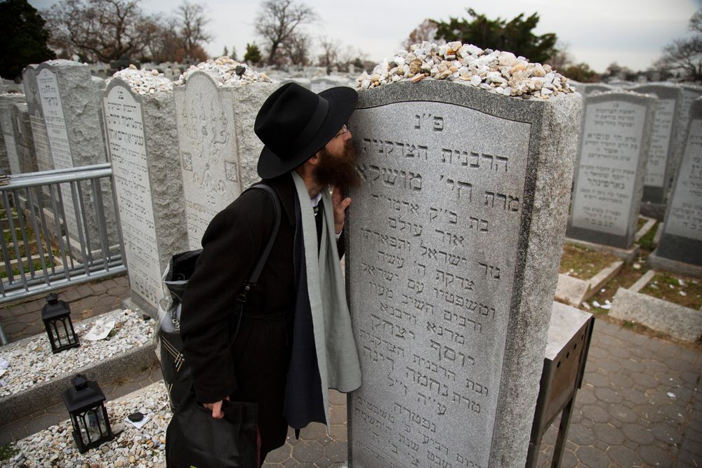 In this Nov. 22, 2019, photo, a rabbi kisses the headstone of Chaya Mushka Schneerson, the wife of Rabbi Menachem Mendel Schneerson, known as the Lubavitcher Rebbe, while attending the annual International Conference of Chabad-Lubavitch Emissaries at Montefiore Cemetery in New York. The annual conference included seminars, a class photo of all 5,800 rabbis in attendance and an evening dinner. (AP Photo/Jessie Wardarski) In this Nov. 22, 2019, photo, a rabbi kisses the headstone of Chaya Mushka Schneerson, the wife of Rabbi Menachem Mendel Schneerson, known as the Lubavitcher Rebbe, while attending the annual International Conference of Chabad-Lubavitch Emissaries at Montefiore Cemetery in New York. The annual conference included seminars, a class photo of all 5,800 rabbis in attendance and an evening dinner. (AP Photo/Jessie Wardarski)
