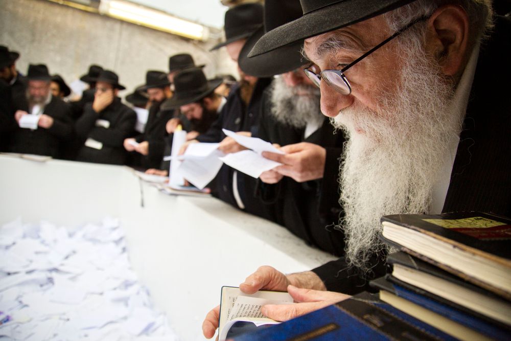 In this Nov. 22, 2019, photo, Hasidic leaders read personal notes and prayers at the resting place of the late Rabbi Menachem Mendel Schneerson, known as the Lubavitcher Rebbe, while attending the annual International Conference of Chabad-Lubavitch Emissaries at Montefiore Cemetery in New York. The annual conference included seminars, a class photo of about 5,800 rabbis in attendance and an evening dinner. (AP Photo/Jessie Wardarski) In this Nov. 22, 2019, photo, Hasidic leaders read personal notes and prayers at the resting place of the late Rabbi Menachem Mendel Schneerson, known as the Lubavitcher Rebbe, while attending the annual International Conference of Chabad-Lubavitch Emissaries at Montefiore Cemetery in New York. The annual conference included seminars, a class photo of about 5,800 rabbis in attendance and an evening dinner. (AP Photo/Jessie Wardarski)