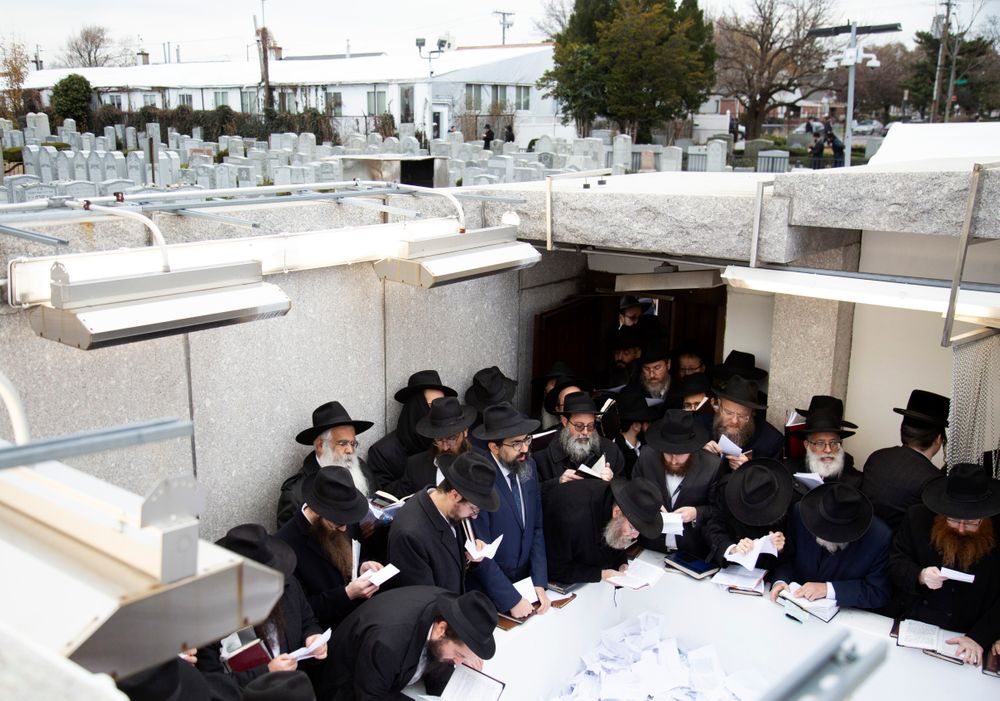 In this Nov. 22, 2019, photo, Hasidic leaders read personal notes and prayers at the resting place of the late Rabbi Menachem Mendel Schneerson, known as the Lubavitcher Rebbe, while attending the annual International Conference of Chabad-Lubavitch Emissaries at Montefiore Cemetery in New York. The annual conference included seminars, a class photo of about 5,800 rabbis in attendance and an evening dinner. (AP Photo/Jessie Wardarski) In this Nov. 22, 2019, photo, Hasidic leaders read personal notes and prayers at the resting place of the late Rabbi Menachem Mendel Schneerson, known as the Lubavitcher Rebbe, while attending the annual International Conference of Chabad-Lubavitch Emissaries at Montefiore Cemetery in New York. The annual conference included seminars, a class photo of about 5,800 rabbis in attendance and an evening dinner. (AP Photo/Jessie Wardarski)