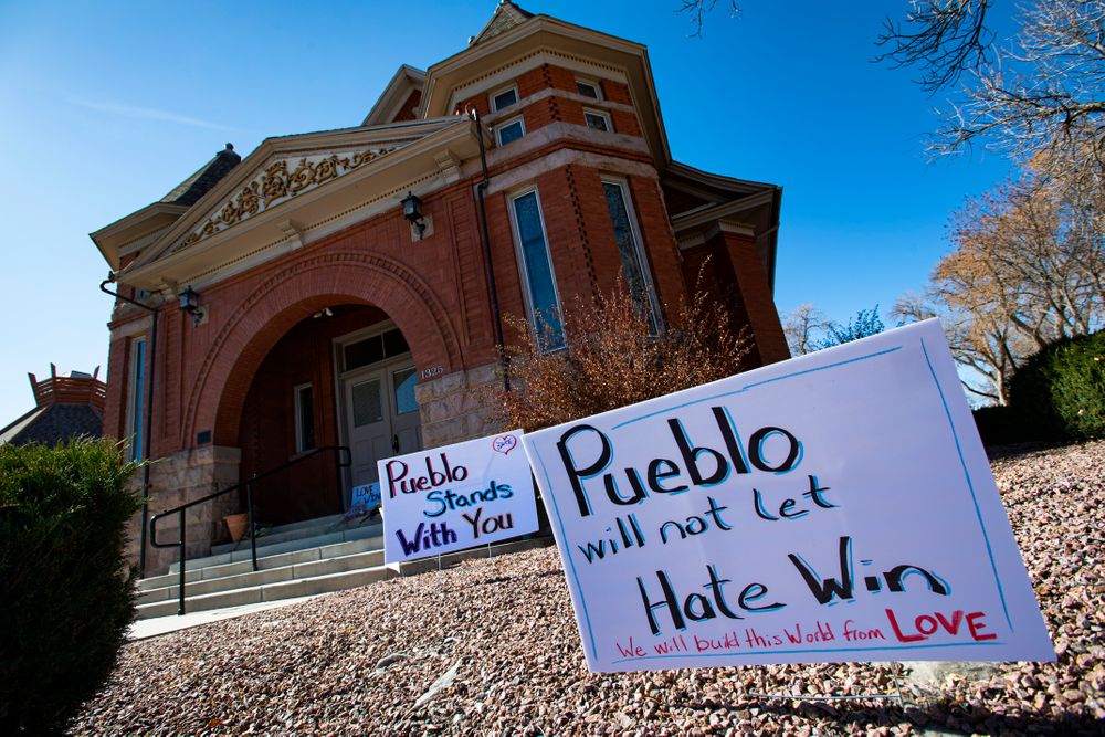 Signs, flowers and candles expressing love for the Jewish community stand outside the Temple Emanuel in Pueblo, Colo., Tuesday, Nov. 5, 2019. Richard Holzer, 27, of Pueblo was arrested Friday by the FBI after he allegedly said he was going to go blow up the temple because he hates Jews. Temple president Michael Atlas-Acuña found the items when he arrived in the morning. (Christian Murdock/The Gazette via AP) Signs, flowers and candles expressing love for the Jewish community stand outside the Temple Emanuel in Pueblo, Colo., Tuesday, Nov. 5, 2019. Richard Holzer, 27, of Pueblo was arrested Friday by the FBI after he allegedly said he was going to go blow up the temple because he hates Jews. Temple president Michael Atlas-Acuña found the items when he arrived in the morning. (Christian Murdock/The Gazette via AP)