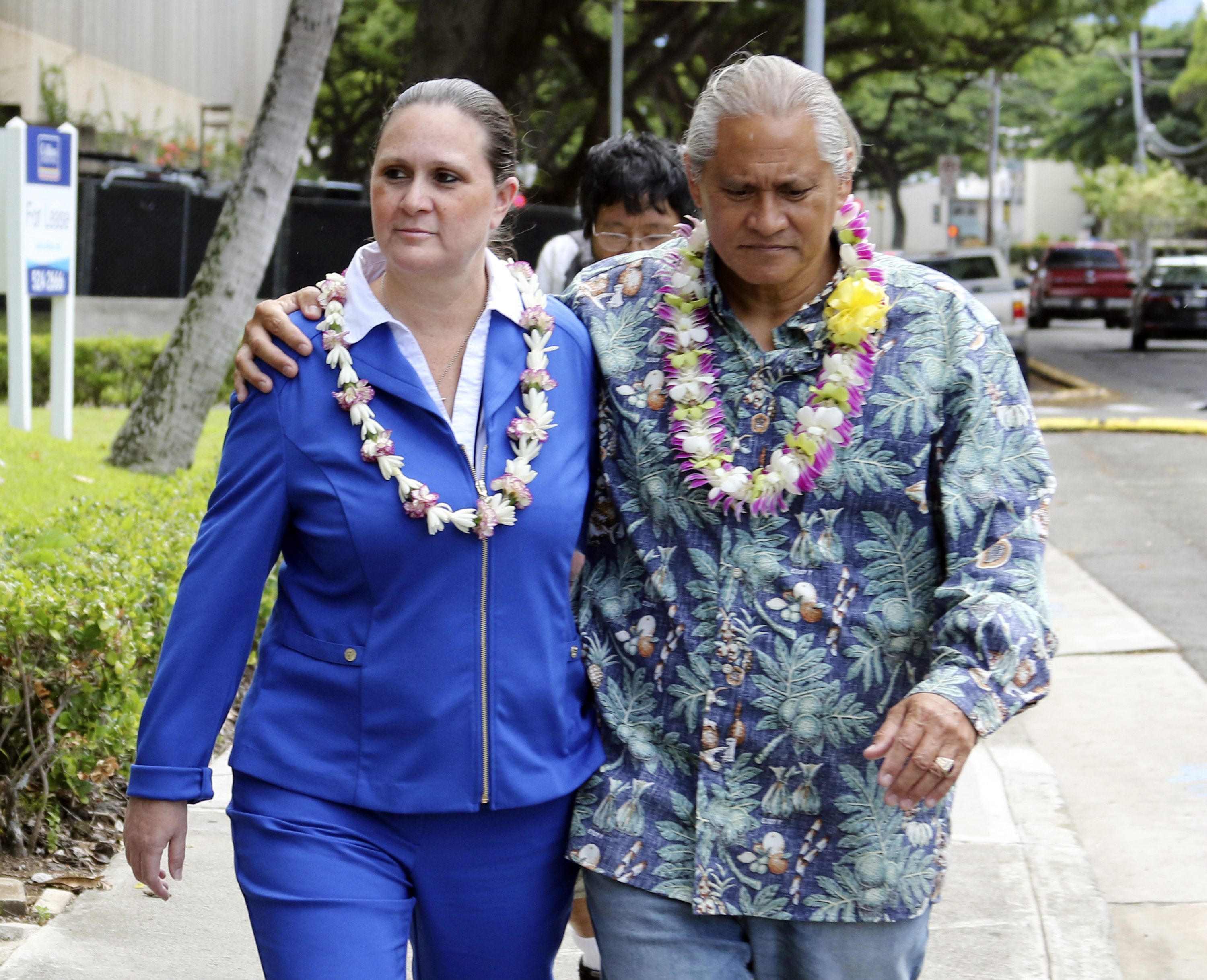 FILE - In this Oct. 20, 2017 file photo, former Honolulu Police Chief Louis Kealoha and his wife Katherine Keahola leave federal court in Honolulu. The city of Honolulu's chief legal officer has received a target letter linked to an ongoing federal corruption investigation. Mayor Kirk Caldwell says Corporation Counsel Donna Leong is taking a paid leave of absence, effective Monday, Jan. 14, 2019. (AP Photo/Caleb Jones, File) FILE - In this Oct. 20, 2017 file photo, former Honolulu Police Chief Louis Kealoha and his wife Katherine Keahola leave federal court in Honolulu. The city of Honolulu's chief legal officer has received a target letter linked to an ongoing federal corruption investigation. Mayor Kirk Caldwell says Corporation Counsel Donna Leong is taking a paid leave of absence, effective Monday, Jan. 14, 2019. (AP Photo/Caleb Jones, File)