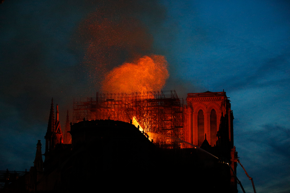 Firefighters use hoses as Notre Dame cathedral burns in Paris, Monday, April 15, 2019. A catastrophic fire engulfed the upper reaches of Paris' soaring Notre Dame Cathedral as it was undergoing renovations Monday, threatening one of the greatest architectural treasures of the Western world as tourists and Parisians looked on aghast from the streets below. (AP Photo/Francois Mori) Firefighters use hoses as Notre Dame cathedral burns in Paris, Monday, April 15, 2019. A catastrophic fire engulfed the upper reaches of Paris' soaring Notre Dame Cathedral as it was undergoing renovations Monday, threatening one of the greatest architectural treasures of the Western world as tourists and Parisians looked on aghast from the streets below. (AP Photo/Francois Mori)