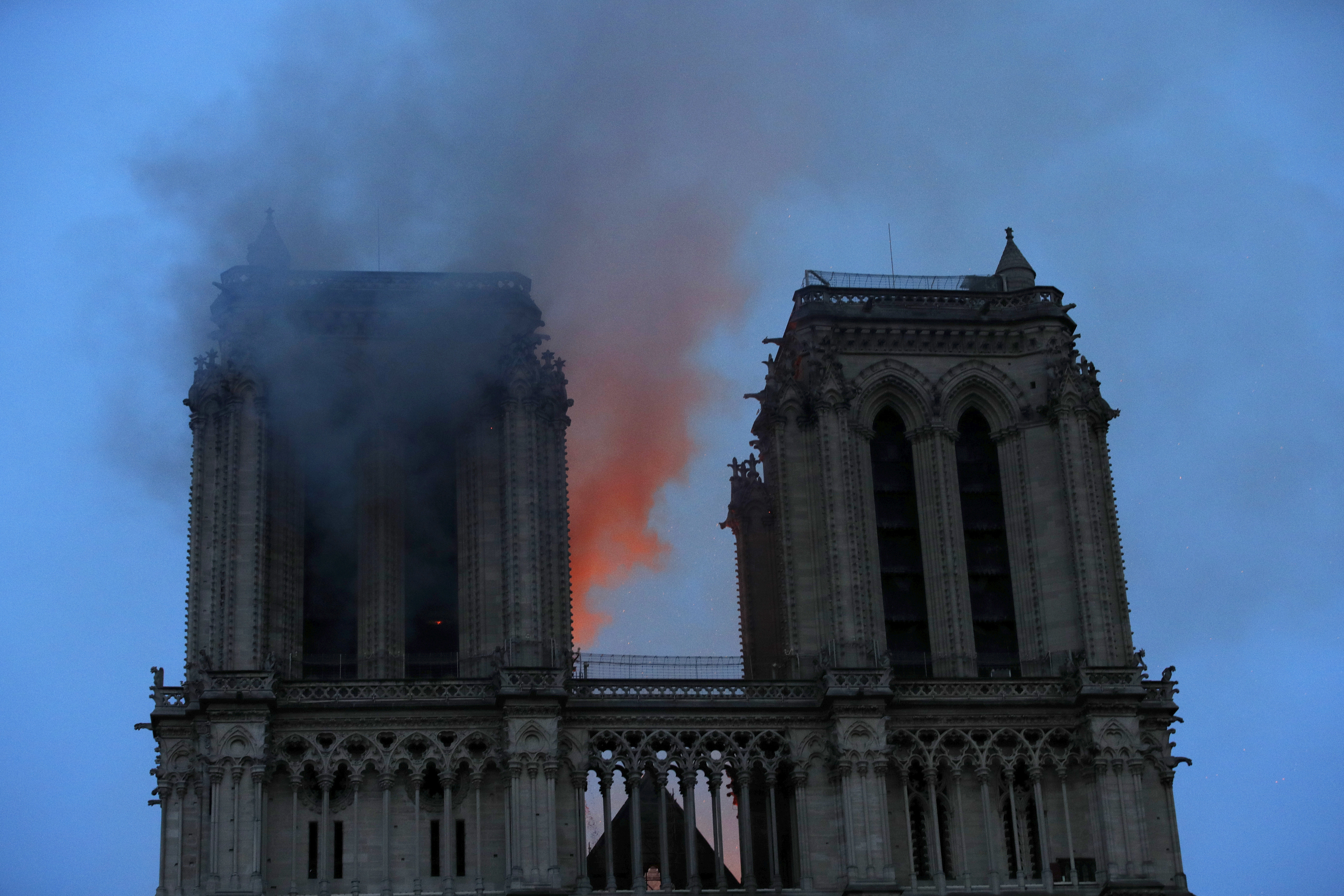 Smoke and flames fill the sky as a fire burns at the Notre Dame Cathedral during the visit by French President Emmanuel Macron in Paris, Monday, April 15, 2019. A catastrophic fire engulfed the upper reaches of Paris' soaring Notre Dame Cathedral as it was undergoing renovations Monday, threatening one of the greatest architectural treasures of the Western world as tourists and Parisians looked on aghast from the streets below.(Philippe Wojazer/Pool via AP) Smoke and flames fill the sky as a fire burns at the Notre Dame Cathedral during the visit by French President Emmanuel Macron in Paris, Monday, April 15, 2019. A catastrophic fire engulfed the upper reaches of Paris' soaring Notre Dame Cathedral as it was undergoing renovations Monday, threatening one of the greatest architectural treasures of the Western world as tourists and Parisians looked on aghast from the streets below.(Philippe Wojazer/Pool via AP)