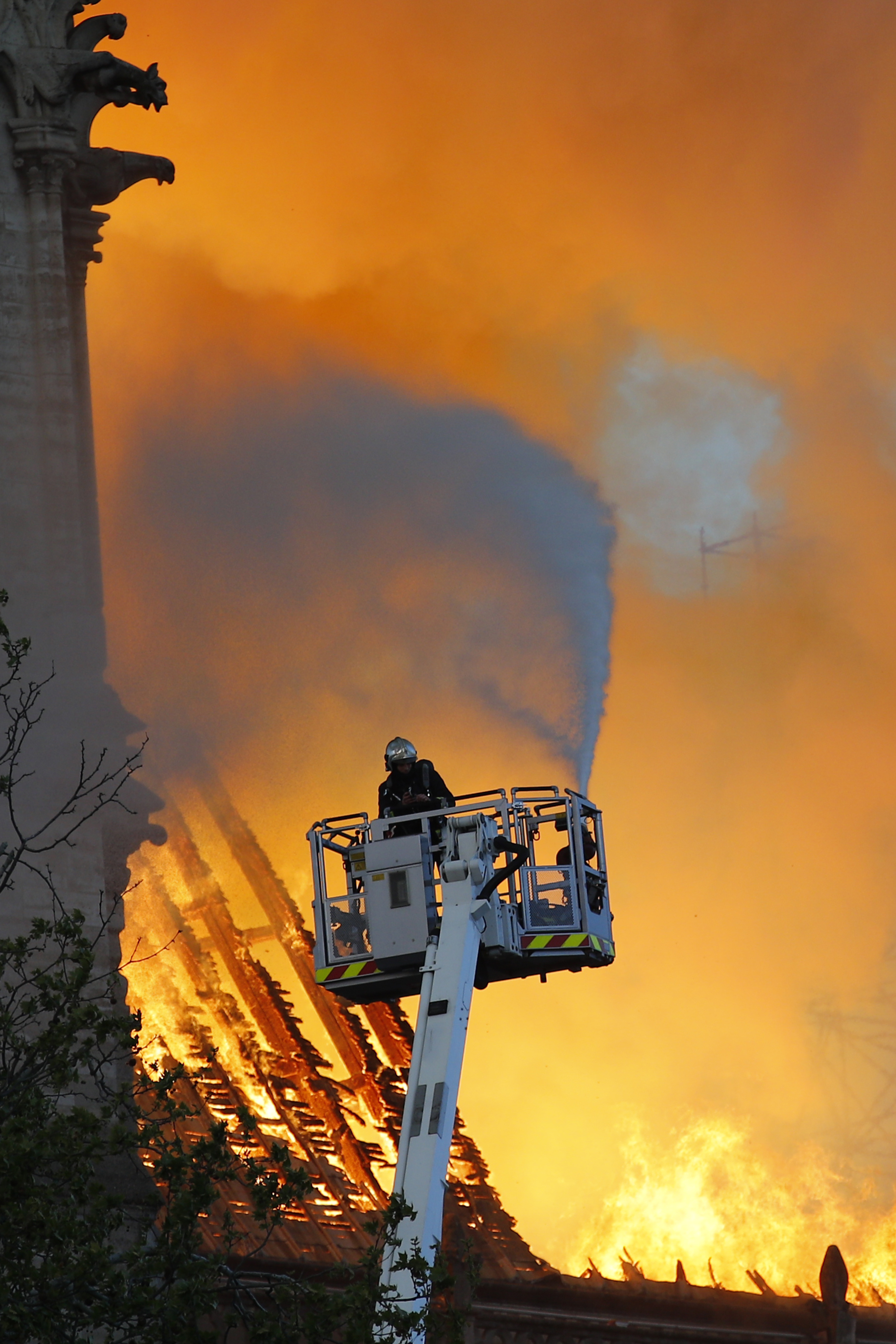 A fire fighter uses a hose as Notre Dame cathedral is burning in Paris, Monday, April 15, 2019. A catastrophic fire engulfed the upper reaches of Paris' soaring Notre Dame Cathedral as it was undergoing renovations Monday, threatening one of the greatest architectural treasures of the Western world as tourists and Parisians looked on aghast from the streets below. (AP Photo/Francois Mori) A fire fighter uses a hose as Notre Dame cathedral is burning in Paris, Monday, April 15, 2019. A catastrophic fire engulfed the upper reaches of Paris' soaring Notre Dame Cathedral as it was undergoing renovations Monday, threatening one of the greatest architectural treasures of the Western world as tourists and Parisians looked on aghast from the streets below. (AP Photo/Francois Mori)
