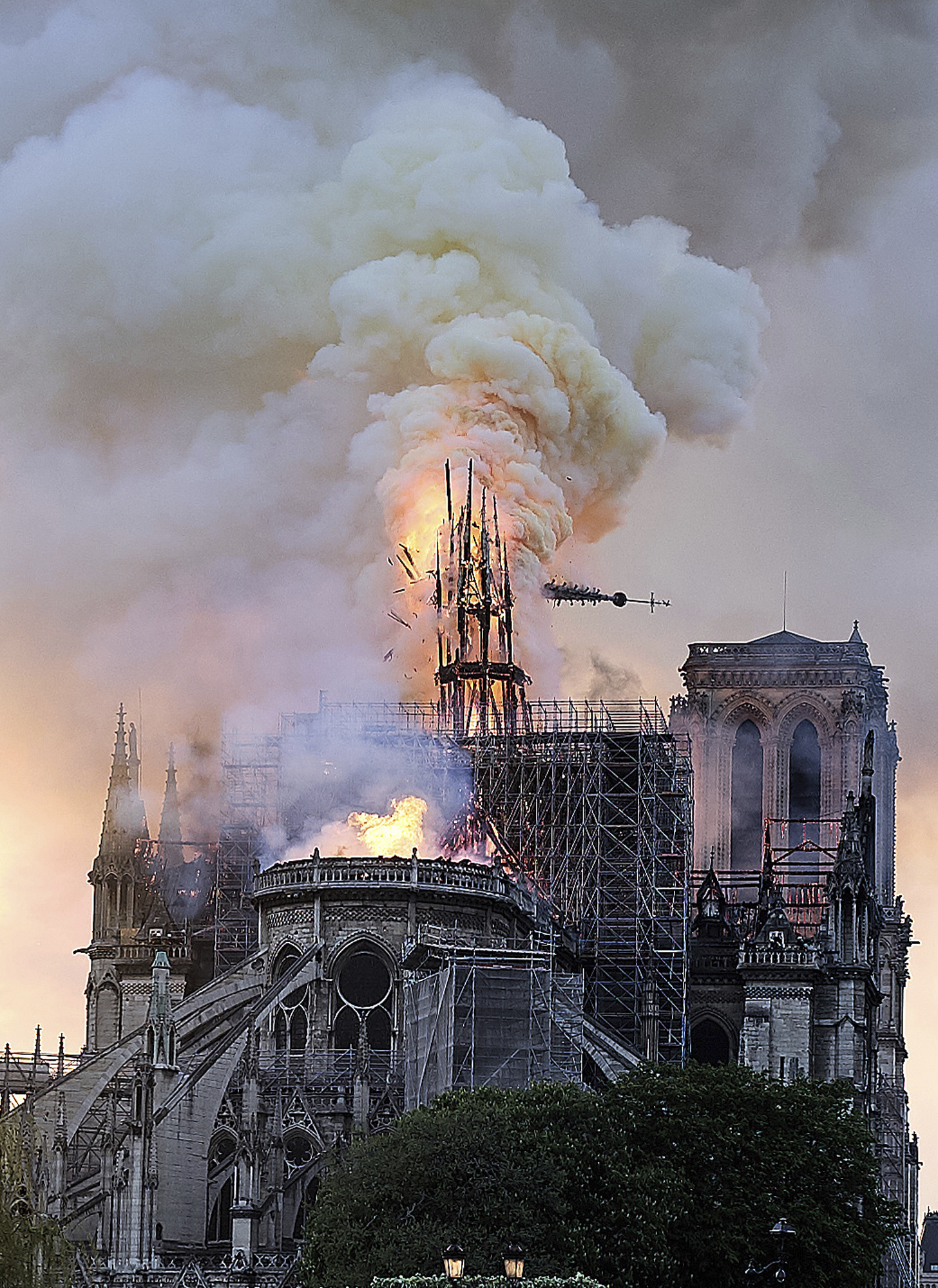 Flames and smoke rise as the spire on Notre Dame cathedral collapses in Paris, Monday, April 15, 2019. Massive plumes of yellow brown smoke is filling the air above Notre Dame Cathedral and ash is falling on tourists and others around the island that marks the center of Paris. (AP Photo/Diana Ayanna) Flames and smoke rise as the spire on Notre Dame cathedral collapses in Paris, Monday, April 15, 2019. Massive plumes of yellow brown smoke is filling the air above Notre Dame Cathedral and ash is falling on tourists and others around the island that marks the center of Paris. (AP Photo/Diana Ayanna)