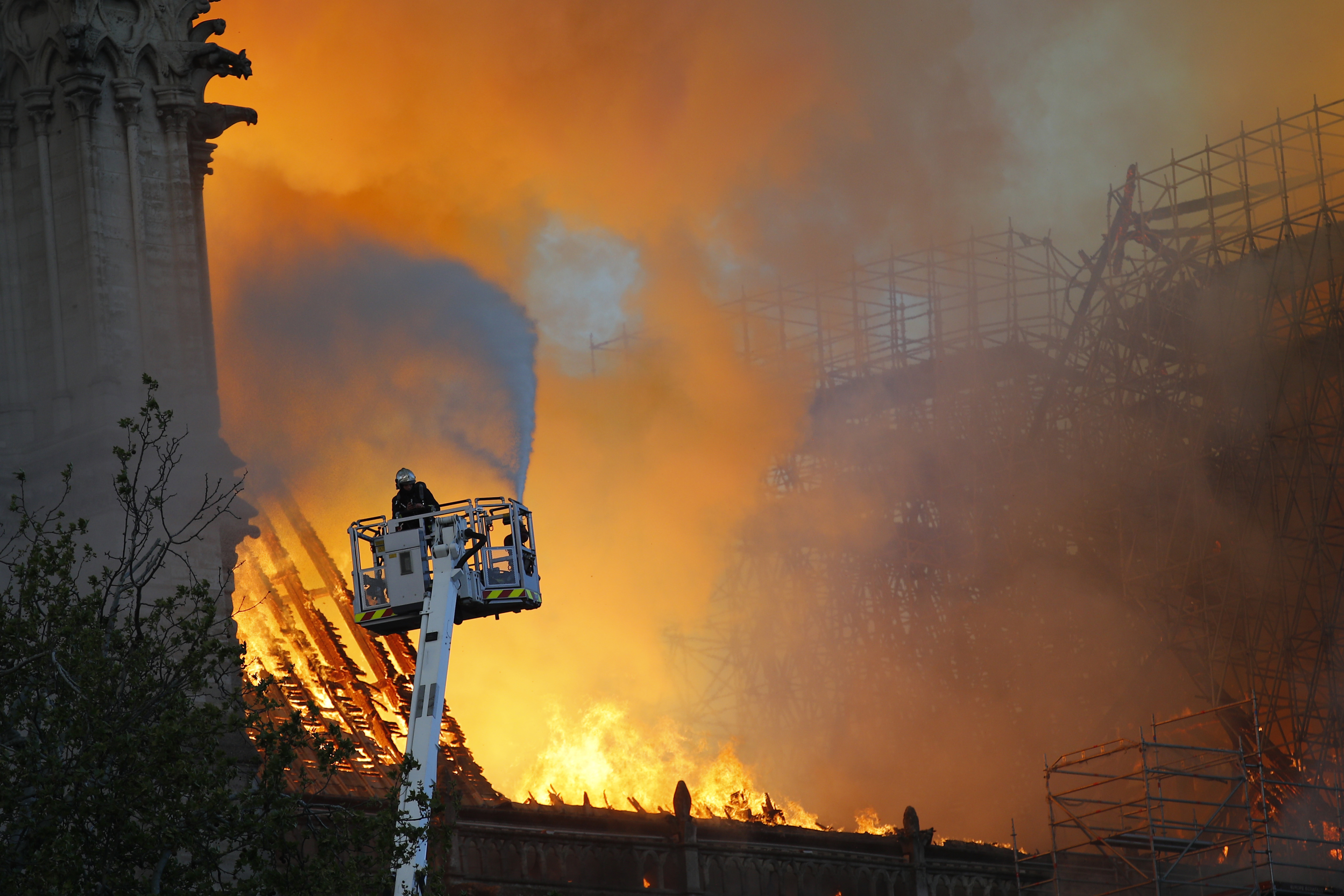 A fire fighter uses a hose as Notre Dame cathedral is burning in Paris, Monday, April 15, 2019. A catastrophic fire engulfed the upper reaches of Paris' soaring Notre Dame Cathedral as it was undergoing renovations Monday, threatening one of the greatest architectural treasures of the Western world as tourists and Parisians looked on aghast from the streets below. (AP Photo/Francois Mori) A fire fighter uses a hose as Notre Dame cathedral is burning in Paris, Monday, April 15, 2019. A catastrophic fire engulfed the upper reaches of Paris' soaring Notre Dame Cathedral as it was undergoing renovations Monday, threatening one of the greatest architectural treasures of the Western world as tourists and Parisians looked on aghast from the streets below. (AP Photo/Francois Mori)
