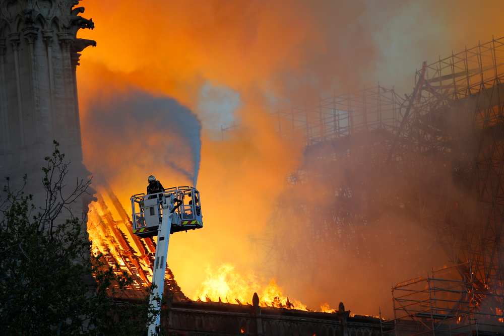 A fire fighter uses a hose as Notre Dame cathedral is burning in Paris, Monday, April 15, 2019. A catastrophic fire engulfed the upper reaches of Paris' soaring Notre Dame Cathedral as it was undergoing renovations Monday, threatening one of the greatest architectural treasures of the Western world as tourists and Parisians looked on aghast from the streets below. (AP Photo/Francois Mori) A fire fighter uses a hose as Notre Dame cathedral is burning in Paris, Monday, April 15, 2019. A catastrophic fire engulfed the upper reaches of Paris' soaring Notre Dame Cathedral as it was undergoing renovations Monday, threatening one of the greatest architectural treasures of the Western world as tourists and Parisians looked on aghast from the streets below. (AP Photo/Francois Mori)