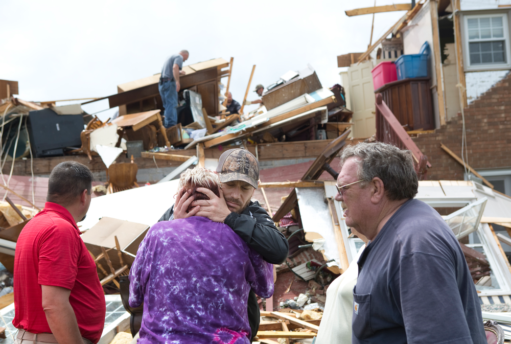 Delores Anderson, 63, center left, looks toward the wreckage of her house while comforted by friends and neighbors who came to support and help pull belongings from her home after it was destroyed by a tornado Friday, April 19, 2019, in Franklin County, Va. (Heather Rousseau/The Roanoke Times via AP) Delores Anderson, 63, center left, looks toward the wreckage of her house while comforted by friends and neighbors who came to support and help pull belongings from her home after it was destroyed by a tornado Friday, April 19, 2019, in Franklin County, Va. (Heather Rousseau/The Roanoke Times via AP)
