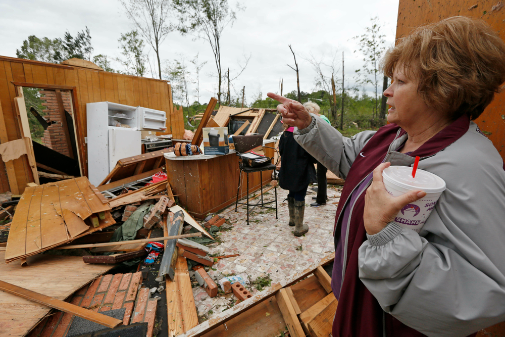 Freda Jenkins looks around the remains of a friend's possible tornado damaged home Friday, April 19, 2019, in Morton, Miss. Strong storms again roared across the South on Thursday, topping trees and leaving a variety of damage in Mississippi, Louisiana and Texas. (AP Photo/Rogelio V. Solis) Freda Jenkins looks around the remains of a friend's possible tornado damaged home Friday, April 19, 2019, in Morton, Miss. Strong storms again roared across the South on Thursday, topping trees and leaving a variety of damage in Mississippi, Louisiana and Texas. (AP Photo/Rogelio V. Solis)